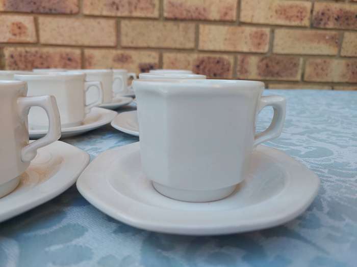A COLLECTION OF EXPRESSO COFFEE CUPS AND SAUCERS