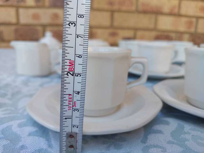 A COLLECTION OF EXPRESSO COFFEE CUPS AND SAUCERS