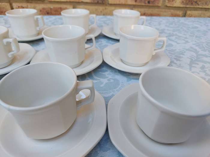 A COLLECTION OF EXPRESSO COFFEE CUPS AND SAUCERS