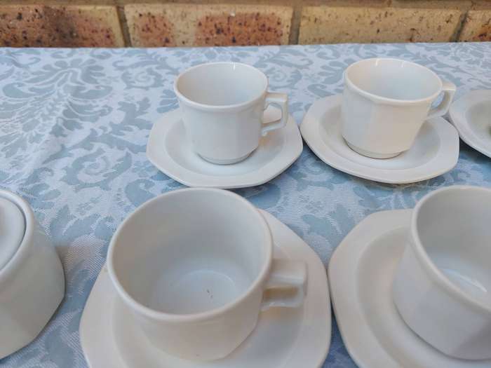 A COLLECTION OF EXPRESSO COFFEE CUPS AND SAUCERS