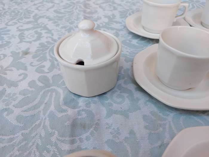 A COLLECTION OF EXPRESSO COFFEE CUPS AND SAUCERS