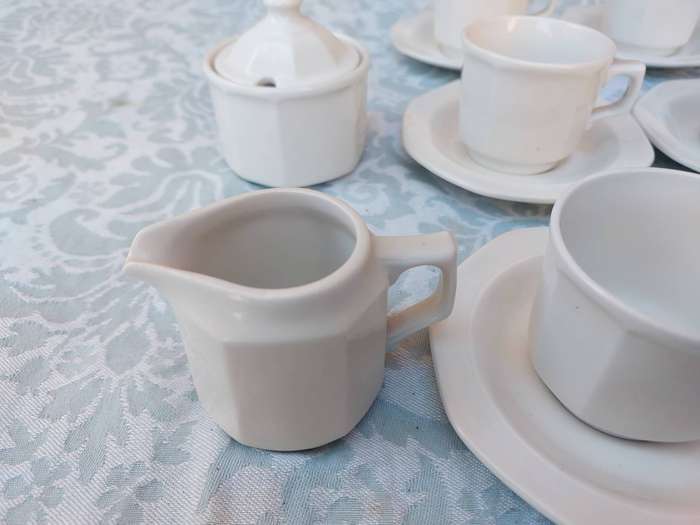 A COLLECTION OF EXPRESSO COFFEE CUPS AND SAUCERS