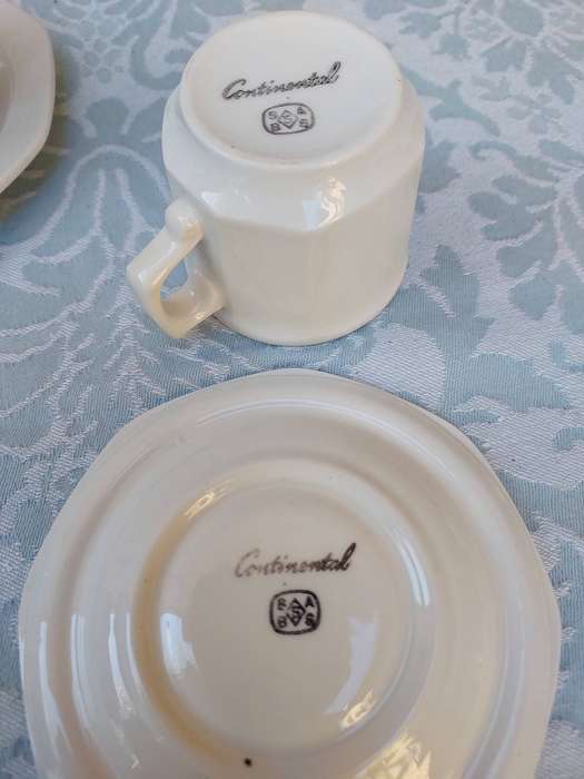 A COLLECTION OF EXPRESSO COFFEE CUPS AND SAUCERS
