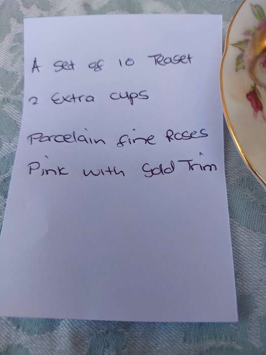 A SET OF 10 TEACUPS AND SAUCERS FINE ROSES WITH GOLD TRIM AND TWO EXTRA CUPS SOLD AS IS