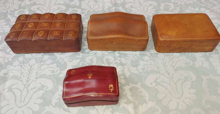 A COLLECTION OF VINTAGE LEATHER-BOUND JEWELRY BOXES SOLD AS IS