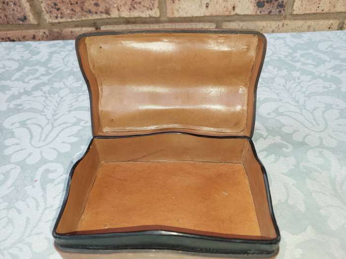 A COLLECTION OF VINTAGE LEATHER-BOUND JEWELRY BOXES SOLD AS IS
