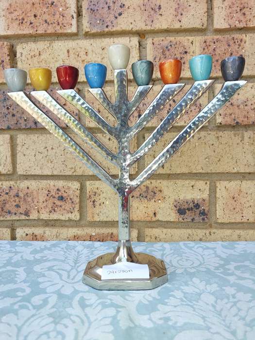 A BEAUTIFULL CHROME PLATED MINORA WITH LAQUERED CANDLE HOLDERS SOLD AS IS