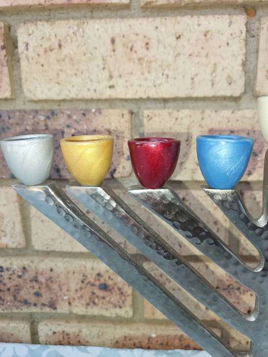 A BEAUTIFULL CHROME PLATED MINORA WITH LAQUERED CANDLE HOLDERS SOLD AS IS