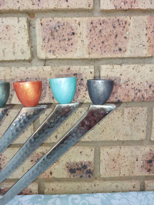 A BEAUTIFULL CHROME PLATED MINORA WITH LAQUERED CANDLE HOLDERS SOLD AS IS