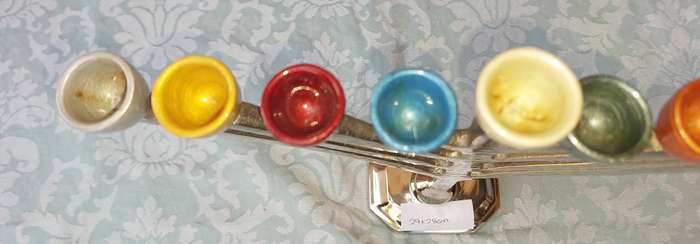 A BEAUTIFULL CHROME PLATED MINORA WITH LAQUERED CANDLE HOLDERS SOLD AS IS