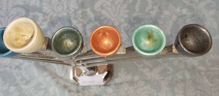 A BEAUTIFULL CHROME PLATED MINORA WITH LAQUERED CANDLE HOLDERS SOLD AS IS