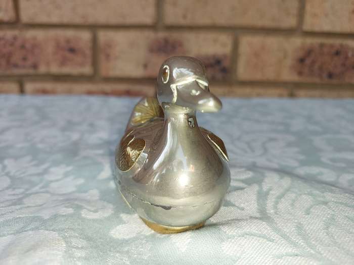 A BEAUTIFUL SILVER PLATE WITH GOLD-PLATED SIDE SALT DISPENSER DUCK SOLD AS IS