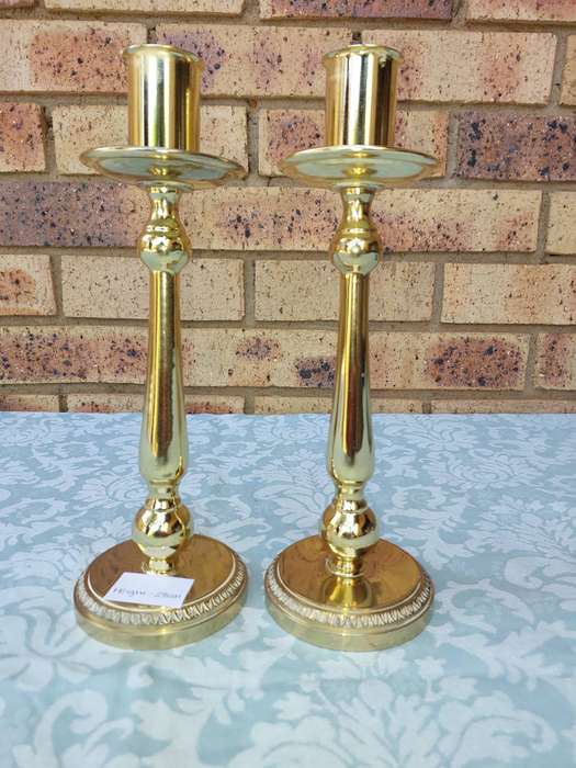A SET OF BRASS ART DECOR CANDLE STANDS SOLD AS IS