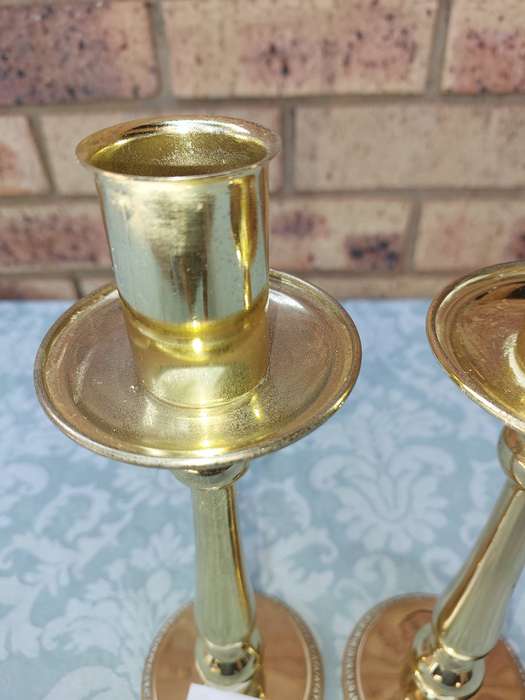 A SET OF BRASS ART DECOR CANDLE STANDS SOLD AS IS