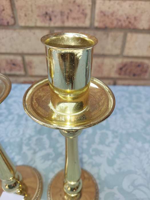 A SET OF BRASS ART DECOR CANDLE STANDS SOLD AS IS