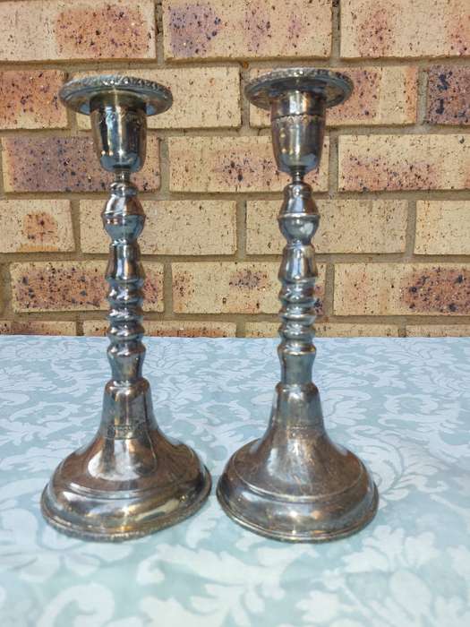 A VINTAGE SET OF SILVER PLATED CANDLE STANDS SOLD AS IS