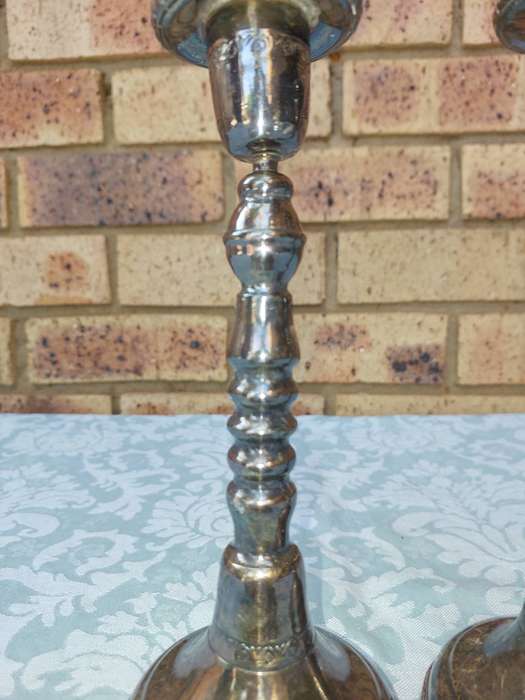A VINTAGE SET OF SILVER PLATED CANDLE STANDS SOLD AS IS