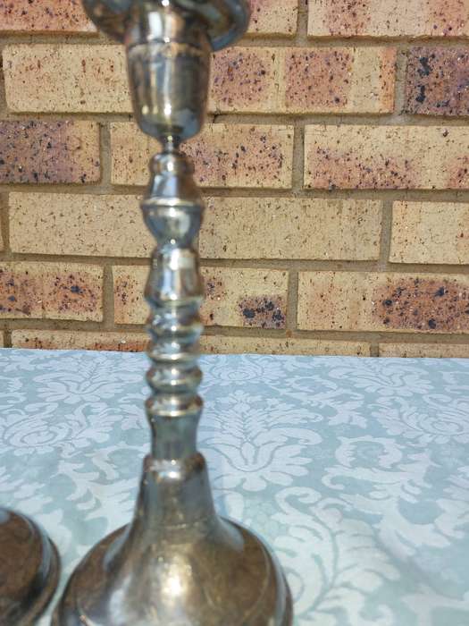 A VINTAGE SET OF SILVER PLATED CANDLE STANDS SOLD AS IS