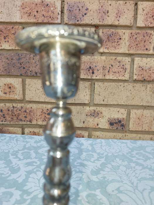 A VINTAGE SET OF SILVER PLATED CANDLE STANDS SOLD AS IS