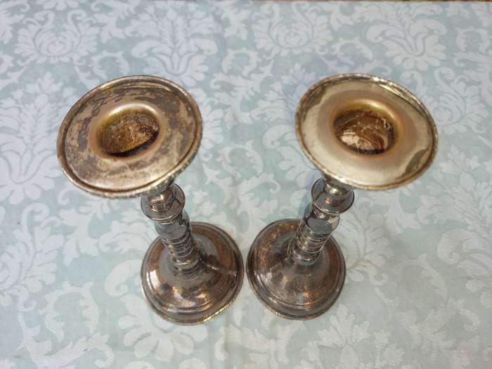 A VINTAGE SET OF SILVER PLATED CANDLE STANDS SOLD AS IS