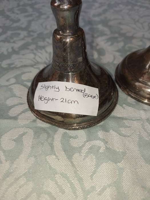 A VINTAGE SET OF SILVER PLATED CANDLE STANDS SOLD AS IS