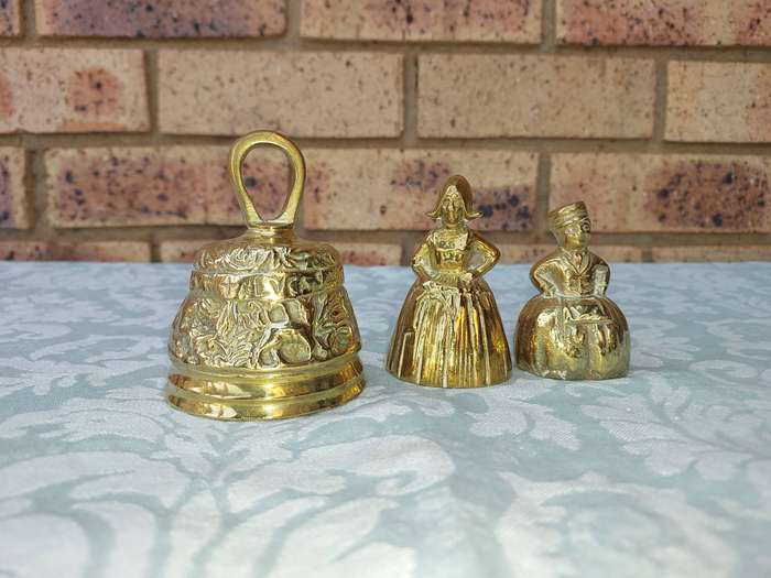 A COLLECTION OF BRASS BELLS SOLD AS IS