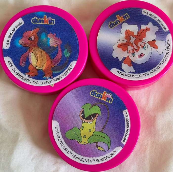 3x Pokémon 1997-2000 Nintendo Dunkin Morphing Tazos on pink containers