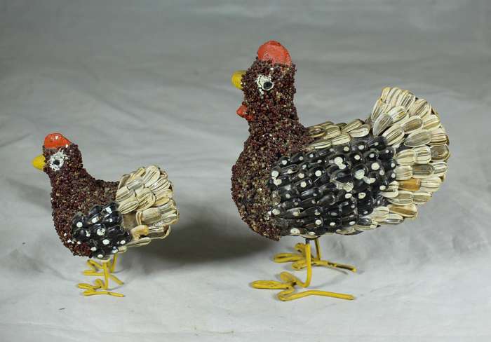 Pair of chickens covered with seeds