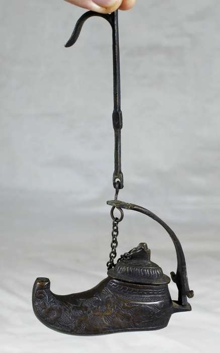 Vintage brass oil lamp in a boot shape