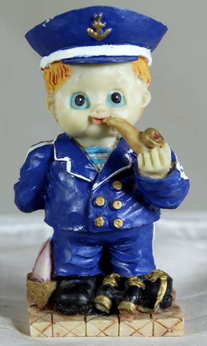 Boy sailor figure smoking a pipe