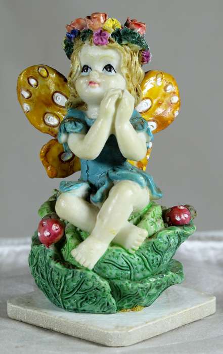 Seated fairy making a wish