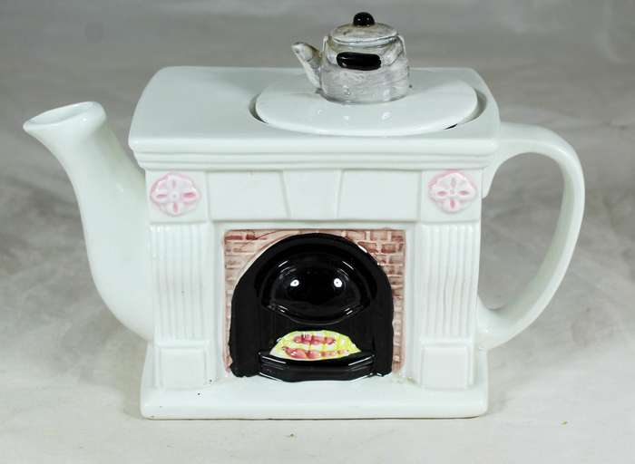 Ornamental porcelain kettle in the shape of a fireplace
