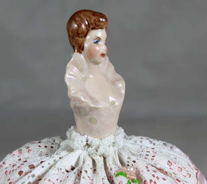 Half doll on a tall pin cushion