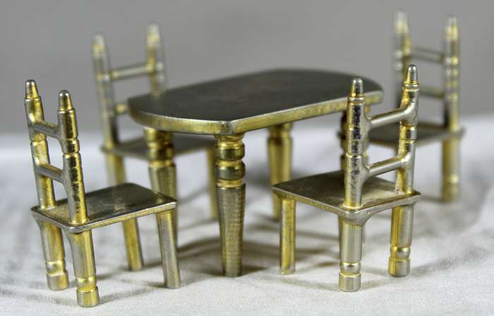Miniature brass table with four chairs