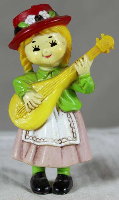 Little girl playing a guitar