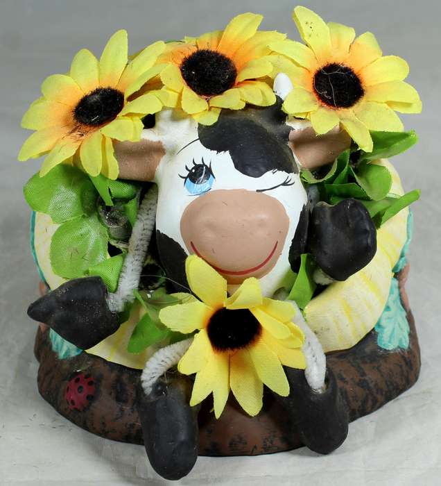 Cow in a pumpkin with sunflowers
