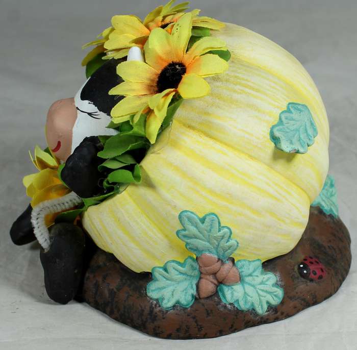 Cow in a pumpkin with sunflowers