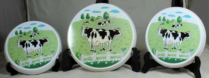 Three cow themed stove top covers