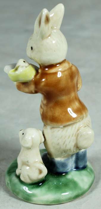Small ceramic rabbit holding a baby