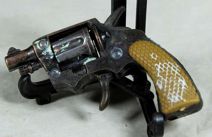Miniature brass revolver with shooting mechanism