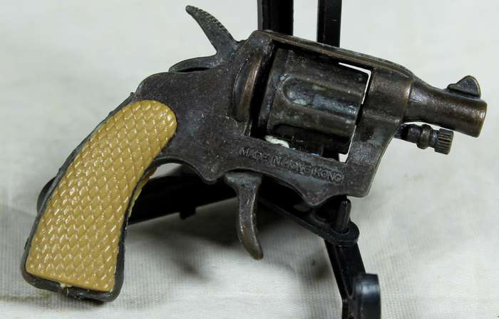 Miniature brass revolver with shooting mechanism
