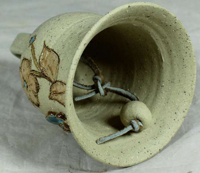 Small pottery bell with embossed swan