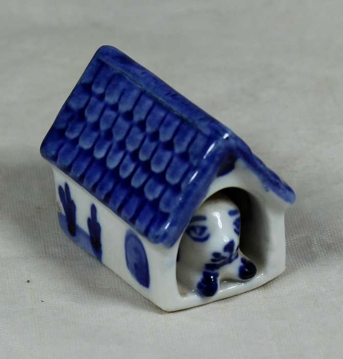 Miniature dog in a doghouse