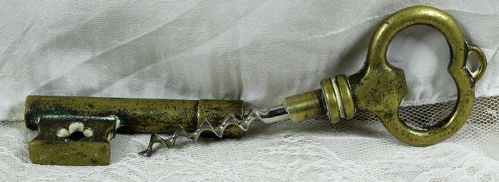 Bronze key bottle opener with cork puller