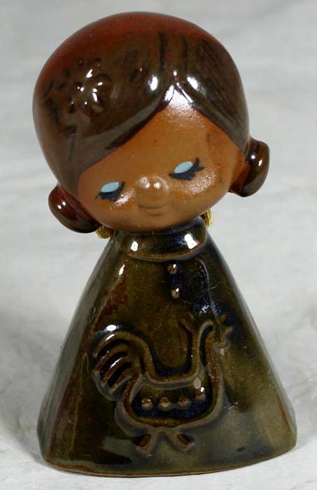 Glazed pottery bell of a little girl