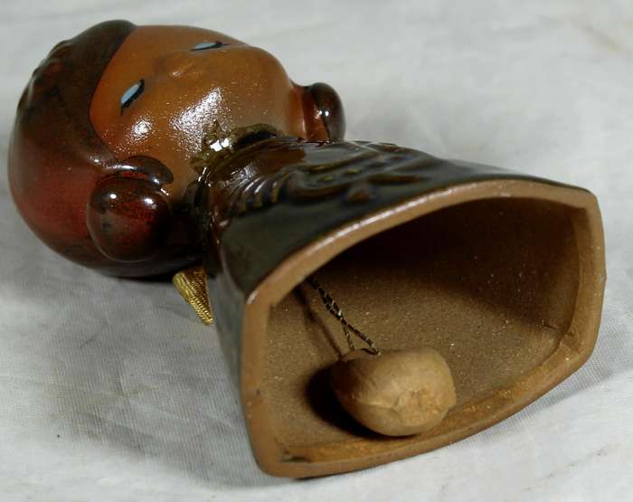Glazed pottery bell of a little girl