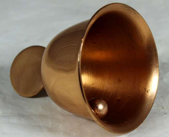 Souvenir copper bell with coin depicting flowers