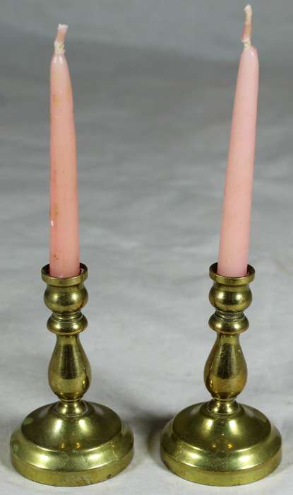 Pair of brass candle holders with candles