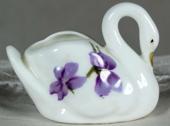Miniature swan with purple violets