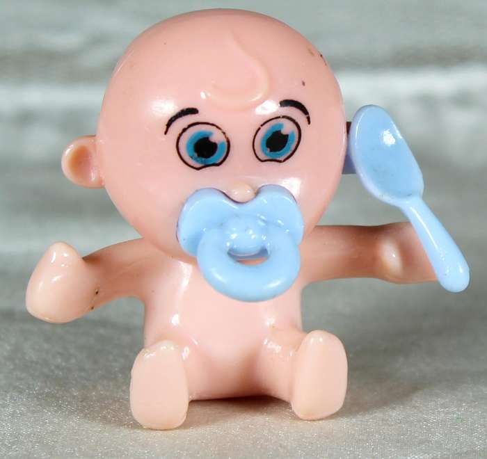 Miniature plastic baby with dummy and spoon
